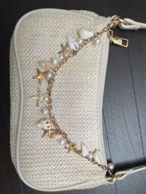 Cream Woven Shoulder Bag With Removeable Sea Shell Chain Detail.
